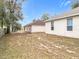 The rear exterior of two houses with bare spot backyards and partial fencing at 250 Ryans Ridge Ave, Eustis, FL 32726