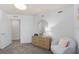 Bright bedroom featuring white walls, plush carpet, and a round gold mirror at 2526 Winsome Way, Davenport, FL 33896