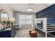 Stylish bedroom with bunkbeds, a blue accent wall with stars, and a bright window at 2526 Winsome Way, Davenport, FL 33896