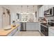 Bright kitchen featuring stainless steel appliances, white cabinets, and a view into the living area at 2526 Winsome Way, Davenport, FL 33896