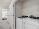 Bright laundry room with side-by-side washer and dryer, and a white door at 2526 Winsome Way, Davenport, FL 33896