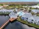 Aerial view of the community featuring a waterfront pool, clubhouse, and beautifully maintained grounds at 2540 Woodgate Blvd # 106, Orlando, FL 32822