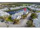 Aerial view of the condo complex highlighting water views, community layout, and green spaces at 2540 Woodgate Blvd # 106, Orlando, FL 32822