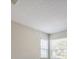 Bedroom ceiling with popcorn style finish and neutral walls at 2540 Woodgate Blvd # 106, Orlando, FL 32822