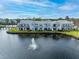 Exterior of condo showing back patio that opens to lake with fountain at 2540 Woodgate Blvd # 106, Orlando, FL 32822