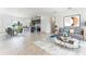 Open concept living room featuring tile floors, stylish furniture, and natural light, adjacent to the modern kitchen at 267 Marion Oaks Golf Rd, Ocala, FL 34473