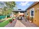 Backyard patio area with brick pavers, a gazebo and outdoor furniture, and well manicured garden at 281 Edisto Pl, Apopka, FL 32712