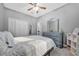 Cozy bedroom featuring gray walls, wood-look flooring, and a ceiling fan at 281 Edisto Pl, Apopka, FL 32712