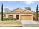 Inviting home exterior featuring a two-car garage and manicured lawn at 281 Edisto Pl, Apopka, FL 32712