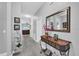 Hallway connecting living areas with a decorative console table and mirror at 281 Edisto Pl, Apopka, FL 32712