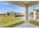 Cozy porch view overlooking the manicured lawn and the side of a neighboring house at 2921 Sunridge Loop, St Cloud, FL 34771