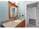 Bathroom boasting granite countertops, wooden cabinets and a bright mirror at 2980 Viscount Cir, Kissimmee, FL 34747