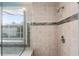 Shower stall featuring decorative tile, glass door, and a built-in seat at 2980 Viscount Cir, Kissimmee, FL 34747