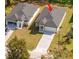 Aerial view highlighting driveway of a well-maintained home on a landscaped lot at 313 Mandrake St, Orlando, FL 32811