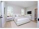 Well-lit bedroom with two windows, light-colored walls, and a view to an ensuite bathroom at 313 Mandrake St, Orlando, FL 32811