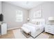 Bright bedroom with modern decor, featuring a large bed, white furniture, and wood flooring at 313 Mandrake St, Orlando, FL 32811