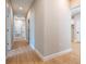 Hallway with recessed lighting and light wood floors leading to various rooms and a bathroom at 313 Mandrake St, Orlando, FL 32811