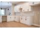 Modern kitchen featuring white cabinets, a stylish backsplash, and stainless steel faucet at 313 Mandrake St, Orlando, FL 32811