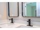 Modern bathroom vanity with dual sinks, quartz countertop, and framed mirrors with black fixtures at 313 Mandrake St, Orlando, FL 32811