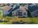 Aerial view of backyard and home with screened-in porch and paver patio at 322 High Vista, Davenport, FL 33837