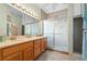 Double sink bathroom with tiled shower and glass door at 322 High Vista, Davenport, FL 33837