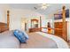 Bedroom featuring TV, four-poster bed, en suite bathroom, and wooden furniture at 322 High Vista, Davenport, FL 33837