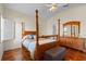 Vaulted ceiling bedroom with four-poster bed, tile floor, and wooden furniture at 322 High Vista, Davenport, FL 33837