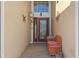 View of the front entryway that features a seating area, red door, and beautiful sidelight windows at 322 High Vista, Davenport, FL 33837