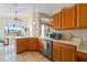 This kitchen features tile flooring, light wood cabinets, and stainless steel appliances at 322 High Vista, Davenport, FL 33837