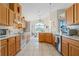 The kitchen features tile flooring, ample light wood cabinetry, and a breakfast bar at 322 High Vista, Davenport, FL 33837