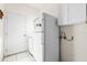 Laundry area featuring white appliances, storage cabinets, and convenient access at 322 High Vista, Davenport, FL 33837