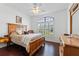 Comfortable main bedroom with wood floors, an arched window, and classic furnishings at 322 High Vista, Davenport, FL 33837