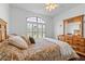 Spacious main bedroom with a dresser, arched window, and a peaceful ambiance at 322 High Vista, Davenport, FL 33837