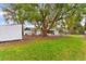 Large backyard with mature trees and playground at 3325 Dove Ln, Mulberry, FL 33860