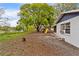 Backyard view with trees, and playground at 3325 Dove Ln, Mulberry, FL 33860