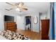 Bedroom showing ceiling fan, spacious closet and wood-look flooring at 3325 Dove Ln, Mulberry, FL 33860