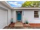 Inviting front entrance with a bright blue door, decorative accents, and well-kept landscaping at 3325 Dove Ln, Mulberry, FL 33860