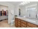 Bathroom with walk-in closet and double sink granite countertop vanity at 3566 Southern Cross Loop, Kissimmee, FL 34744