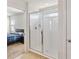 Bright bathroom featuring a glass-enclosed shower with white tile and a view into the bedroom at 3566 Southern Cross Loop, Kissimmee, FL 34744