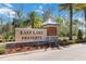 Elegant community sign for East Lake Preserve, surrounded by lush landscaping at 3566 Southern Cross Loop, Kissimmee, FL 34744