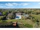 Aerial view showcasing the pool, tennis court, and dock, set amongst the trees and waterside at 4214 Lake Underhill Rd # A, Orlando, FL 32803