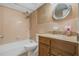 Bathroom featuring a combined tub and shower, vanity with sink, and decorative mirror at 4214 Lake Underhill Rd # A, Orlando, FL 32803