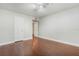 Bedroom featuring hardwood floors, neutral paint, and a closet door, ready for personalization at 4214 Lake Underhill Rd # A, Orlando, FL 32803