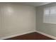 Bedroom featuring paneled walls and a window with plantation shutters at 4214 Lake Underhill Rd # A, Orlando, FL 32803