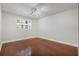 Bright bedroom featuring hardwood floors, a window with shutters, and modern track lighting at 4214 Lake Underhill Rd # A, Orlando, FL 32803