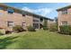 Brick building showcasing lush green lawn, mature shrubs, and a well-manicured exterior at 4214 Lake Underhill Rd # A, Orlando, FL 32803