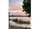 Picturesque lake view with lush vegetation and a serene sunset backdrop at 4214 Lake Underhill Rd # A, Orlando, FL 32803
