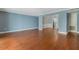 Open-concept living room with hardwood floors and access to the kitchen at 4214 Lake Underhill Rd # A, Orlando, FL 32803