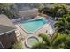 Community pool with lounge chairs and umbrellas surrounded by lush palm trees at 4214 Lake Underhill Rd # A, Orlando, FL 32803