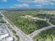 Aerial view of the property surrounded by lush greenery and adjacent to commercial development at 425 Old Chuluota Rd, Chuluota, FL 32766